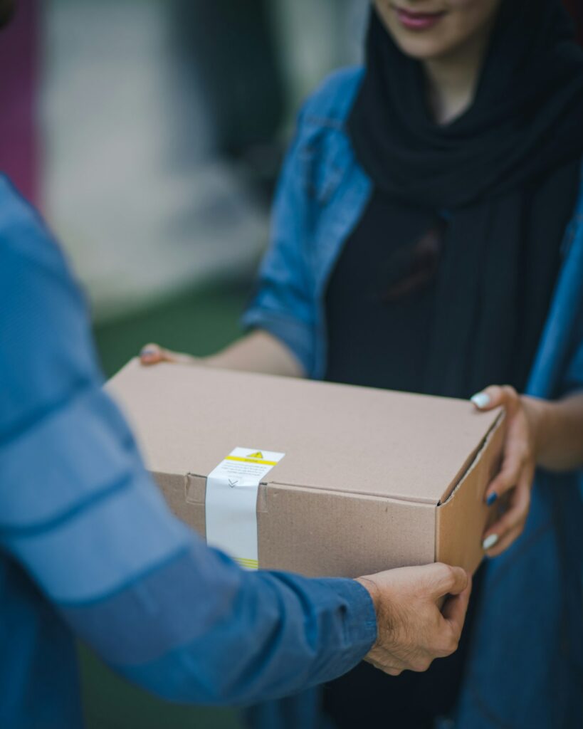 Courier handing over a Ham Dealer delivery box